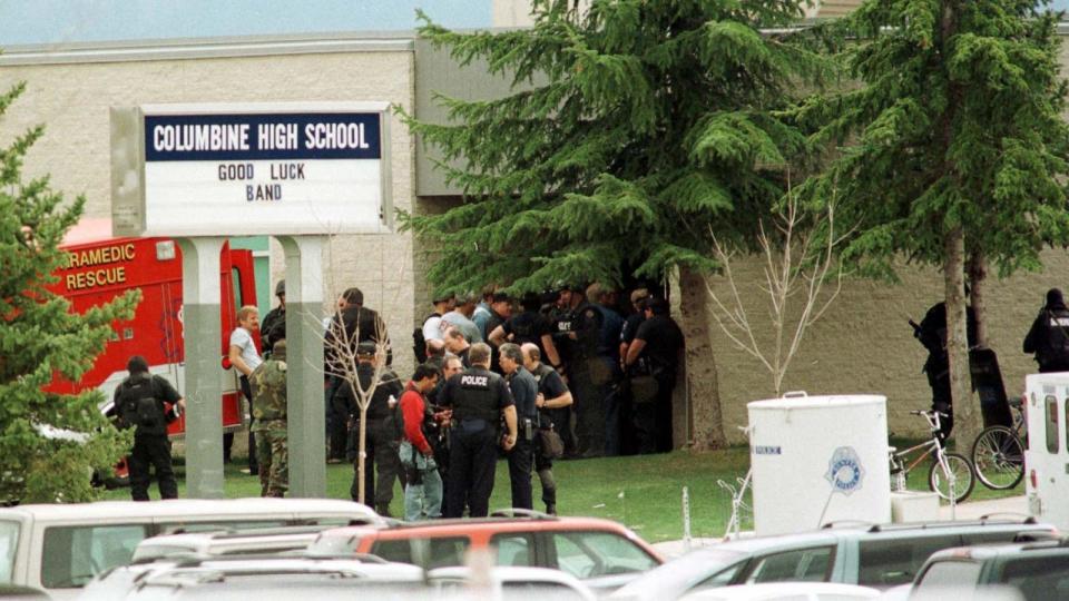 PHOTO: Police stand outside the east entrance of Columbine High shool as bomb squads and SWAT teams secure students, April 20, 1999, in Littleton, Colo. (Mark Leffingwell/AFP via Getty Images)