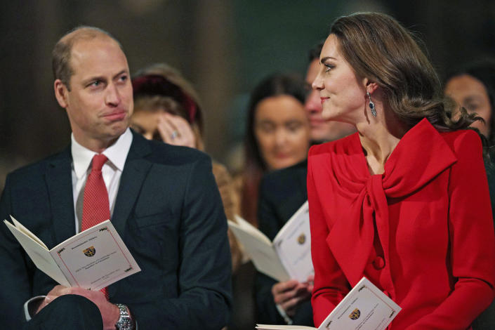 FILE Britain's Prince William, left and Kate, the Duchess of Cambridge attend the 'Royal Carols - Together At Christmas', a Christmas carol concert hosted by the duchess at Westminster Abbey in London, Wednesday Dec. 8, 2021. The world watched as Prince William grew from a towheaded schoolboy to a dashing air-sea rescue pilot to a father of three. But as he turns 40 on Tuesday, June 21, 2022, William is making the biggest change yet: assuming an increasingly central role in the royal family as he prepares for his eventual accession to the throne. (Yui Mok/Pool via AP, File)