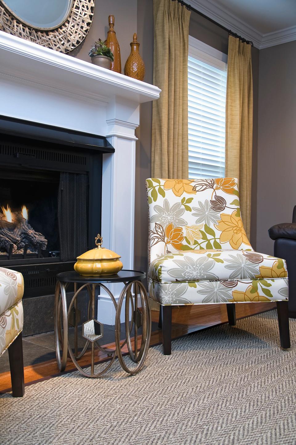 The citrine window treatments complement this accent chair in this redesigned living room in Louisville.