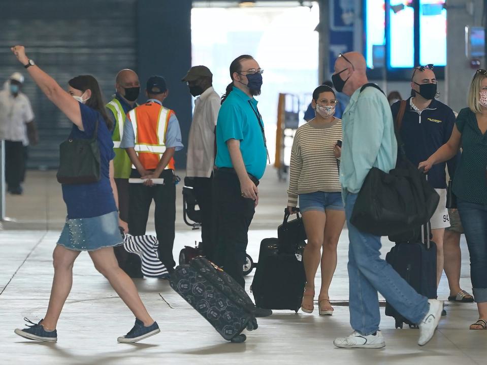 volunteer employees for Royal Caribbean's Freedom of the Seas Sailing walking and holding luggage