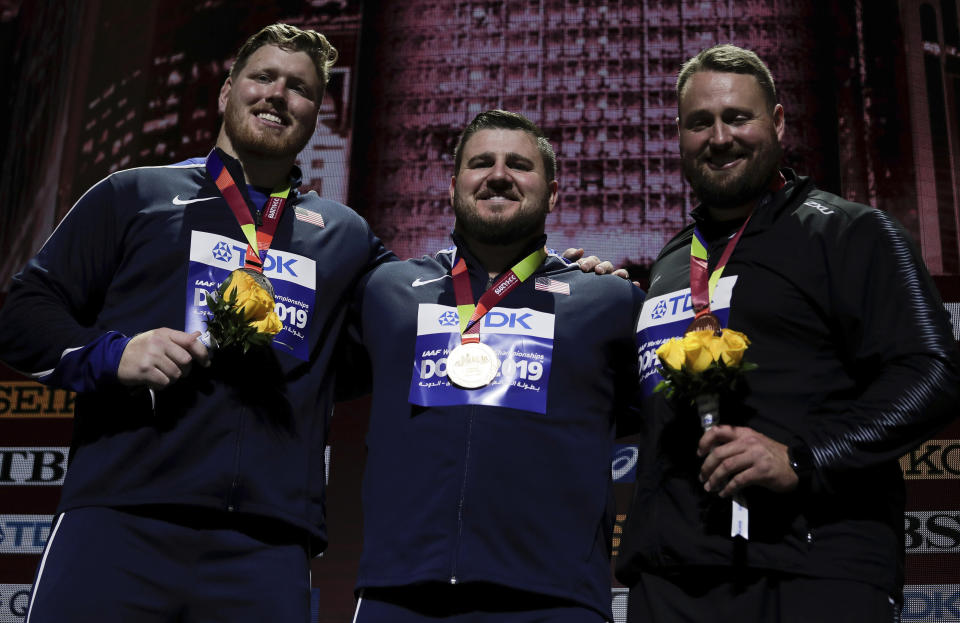 Joe Kovacs, of the United States, gold, Ryan Crouser, of the United States, silver, and Tomas Walsh, of New Zealand, bronze, during the medal ceremony for the men's shot put final at the World Athletics Championships in Doha, Qatar, Saturday, Oct. 5, 2019. (AP Photo/Nariman El-Mofty)