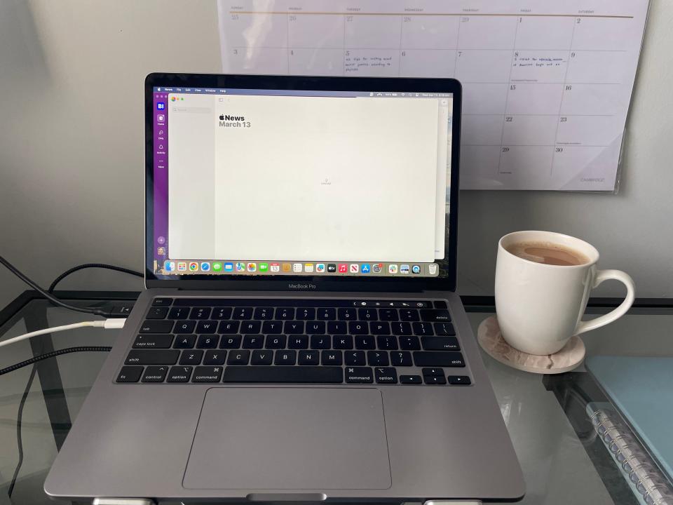 A laptop and cup of coffee.