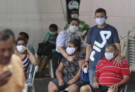 In this April 16, 2020 photo, people suspected of suffering from COVID-19 disease, wait for medical attention outside the 28 de Agosto hospital in Manaus, Amazonas state, Brazil. Manaus’ health care system, already strained before the coronavirus crisis, is buckling under the current onslaught of coronavirus patients. (AP Photo/Edmar Barros)