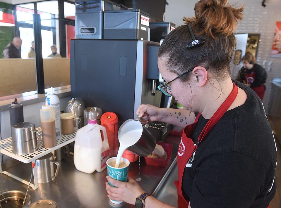 Amanda McDevitt, a barista at Scooter’s Coffee at 2101 W. Ash St., makes a vanilla latte on Friday during the coffee shop’s grand opening. Scooter's Coffee owner Kevin Hall has opened the third Scooter’s Coffee in Columbia.