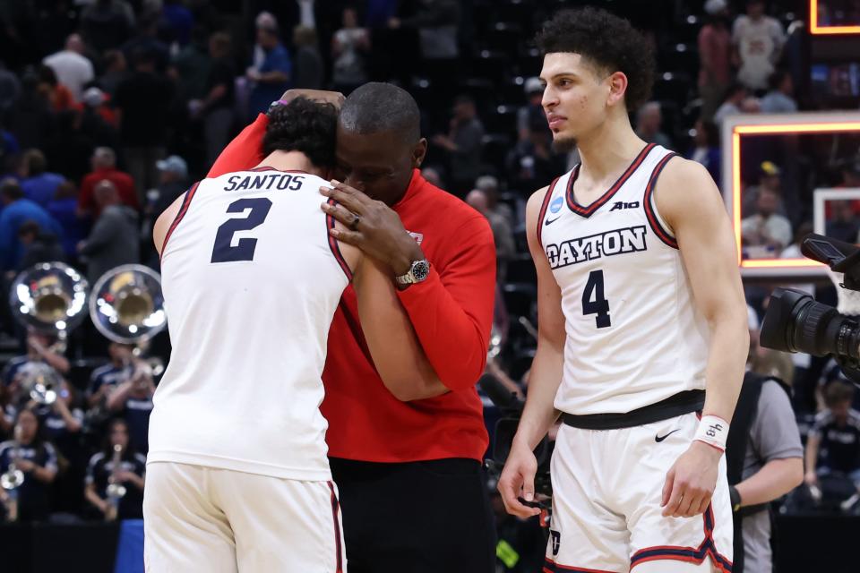 Dayton Flyers forward Nate Santos (2) celebrates with UD head coach Anthony Grant