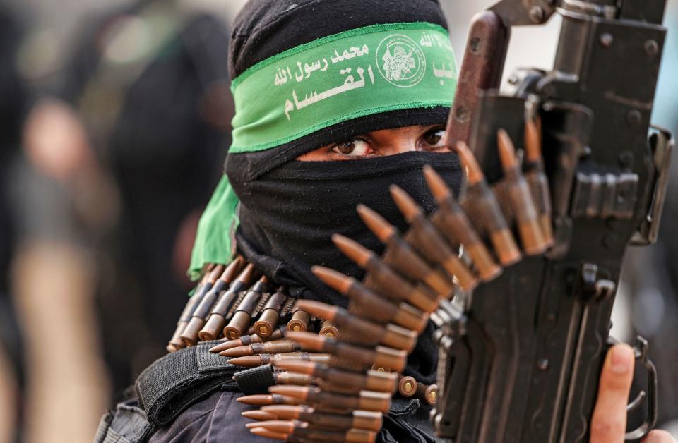 A member of the al-Qassam Brigades, the military wing of the Palestinian Hamas movement, takes part in a parade in Gaza City on November 14, 2021. / Credit: Mahmud Hams/AFP via Getty Images