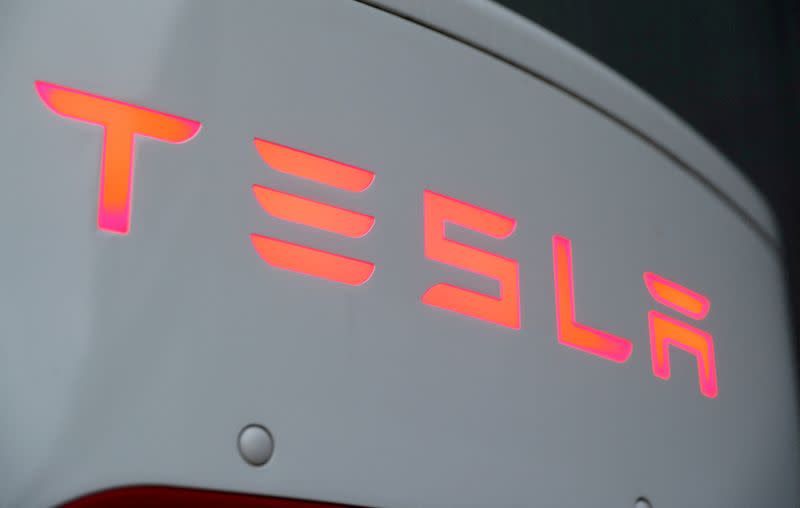 FILE PHOTO: The logo of Tesla is seen at a Tesla Supercharger station