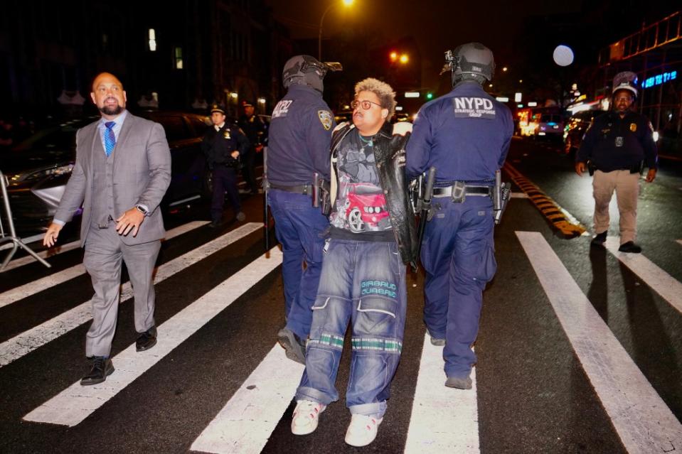 NYPD officers arresting a protester who refused to leave an encampment at City College on April 30, 2024. James Keivom