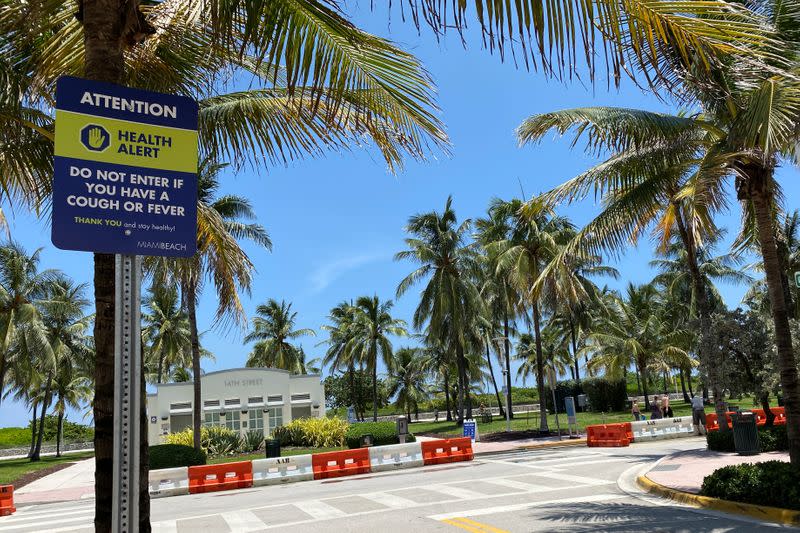 A sign warning about the spread of coronavirus disease is seen in Miami Beach