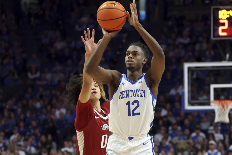 Kentucky's Antonio Reeves (12) shoots while defended by Arkansas' Anthony Black (0) during the first half of an NCAA college basketball game in Lexington, Ky., Tuesday, Feb. 7, 2023. (AP Photo/James Crisp)