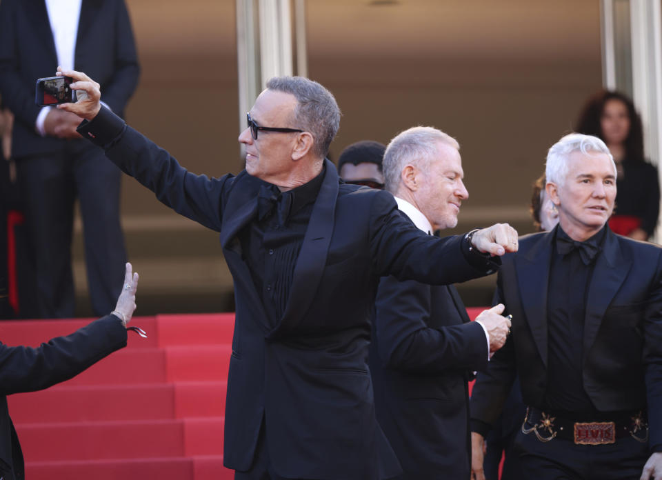 Tom Hanks se toma una selfie en la alfombra roja al llegar al estreno de "Elvis" en el Festival de Cine de Cannes, el miércoles 25 de mayo de 2022 en Cannes, Francia. (Foto por Vianney Le Caer/Invision/AP)