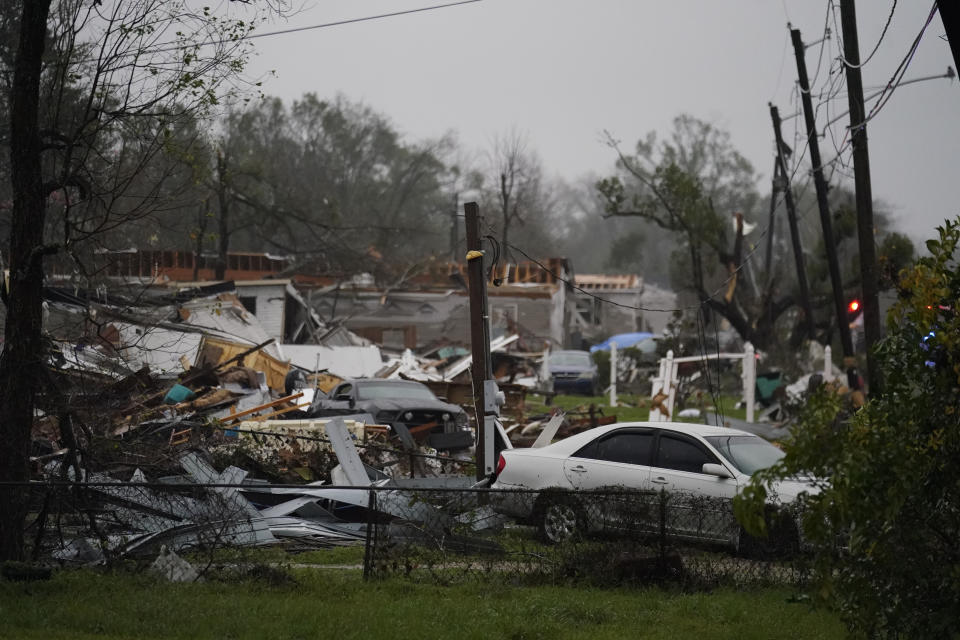 Vehicles and debris are strewn about after a tornado that tore through the area.