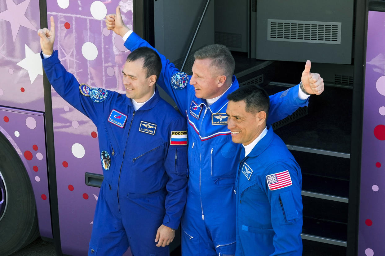 FILE - NASA astronaut Frank Rubio, right, Roscosmos cosmonauts Sergey Prokopyev, center, and Dmitri Petelin, members of the main crew to the International Space Station (ISS), greet their relatives and friends in front of a bus prior the launch of Soyuz-2.1 rocket at the Russian leased Baikonur cosmodrome, Kazakhstan, Sept. 21, 2022. Russian space corporation Roscosmos said Wednesday, Jan. 11, 2023 that it will launch a new spacecraft to take some of the International Space Station's crew back to Earth after their capsule was damaged and leaked coolant (AP Photo/Dmitri Lovetsky, File)