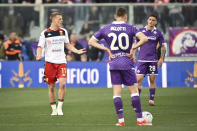 Genoa's Albert Gudmundsson, left, celebrates after scoring his side's opening goal during the Serie A soccer match between Fiorentina and Genoa, at the Artemio Franchi Stadium in Florence, Italy, Monday April 15, 2024. (Massimo Paolone/LaPresse via AP)