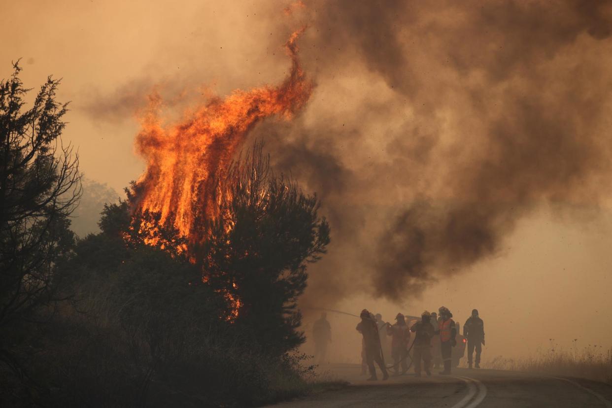 <span>Firefighters work to extinguish a wildfire in Evros, Greece in August last year.</span><span>Photograph: Ayhan Mehmet/Anadolu via Getty Images</span>