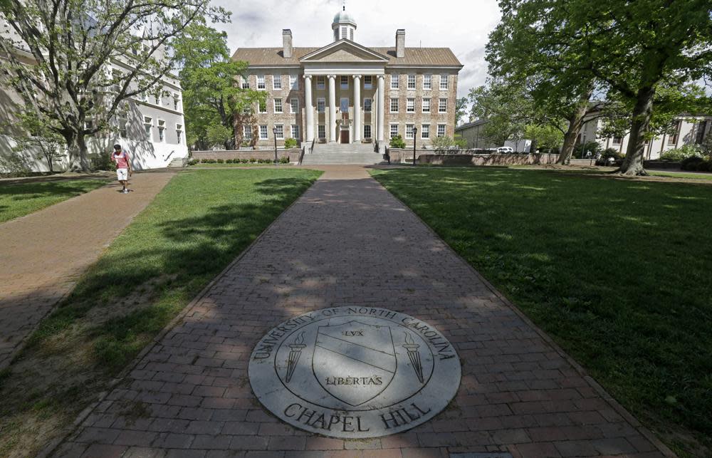 In this Monday, April 20, 2015, photo, a sidewalk leads to the South Building on campus at The University of North Carolina in Chapel Hill, N.C. (AP Photo/Gerry Broome, File)