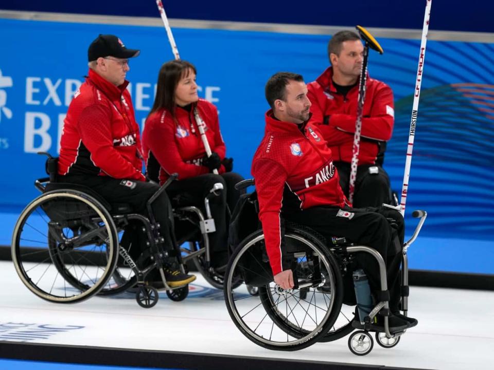 From left, Canada's Dennis Thiessen, Ina Forrest, Jon Thurston, and Mark Ideson are seen at the world wheelchair curling championship in October. The quartet alongside Collinda Joseph were announced as Canada's rink for the Beijing Paralympics on Thursday. (Mark Schiefelbein/The Associated Press - image credit)