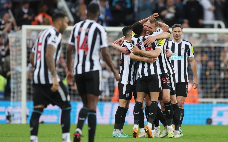 Newcastle United's Dan Burn and Jacob Murphy celebrate after qualifying for the Champions League - Action Images via Reuters