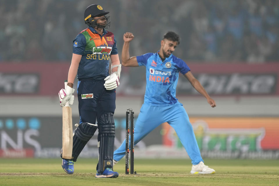 India's Umran Malik, right, celebrates the dismissal of Sri Lanka's Maheesh Theekshana, left, during the third T20 cricket match between India and Sri Lanka, in Rajkot, India, Saturday, Jan. 7, 2023. (AP Photo/Ajit Solanki)