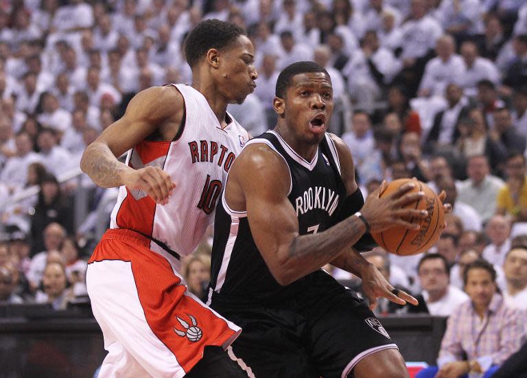 Joe Johnson of the Brooklyn Nets and DeMar DeRozan of the Toronto Raptors in Game Two of the Eastern Conference Quarterfinals at the Air Canada Centre on April 22, 2014