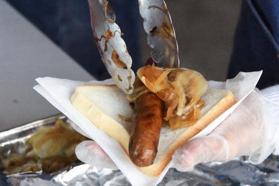 A person prepares a democracy sausage on Election Day in Melbourne, Australia, 18 May 2019. (EPA)