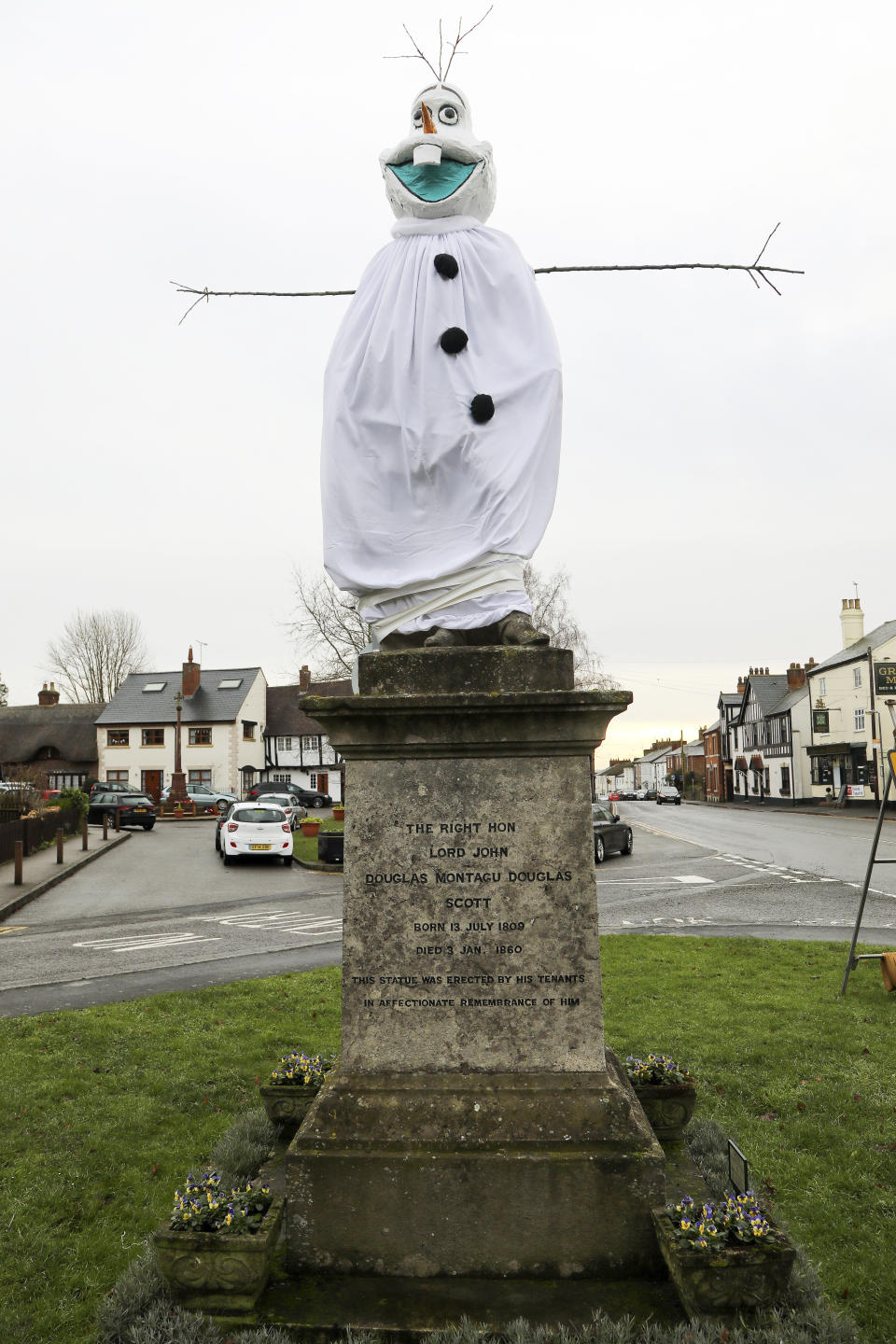 A village is hunting festive pranksters who have turned a statue of its most famous son into PEPPA PIG. The statue of Lord John Scott, who died in 1860, is a Christmas target for jokers in Dunchurch, near Rugby, Warks. Hilarious pictures show the monument draped in a pink sheet with arms stretched out and a huge pink papier mache head resembling kids' TV favourite. The statue has previously been turned into Harry Potter, Shrek, Happy Feet, Pikachu, Homer Simpson, an Olympic athlete and The Grinch in an annual tradition dating back to the 1970s.