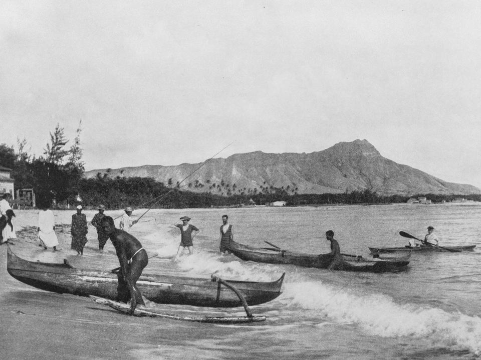 Antique historical photographs from the US Navy and Army of Native Hawaiians with canoes.