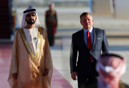 Jordan's King Abdullah II stands next to Prime Minister and Vice-President of the United Arab Emirates and ruler of Dubai Sheikh Mohammed bin Rashid al-Maktoum during a reception ceremony at the Queen Alia International Airport in Amman, Jordan March 28, 2017. REUTERS/Muhammad Hamed