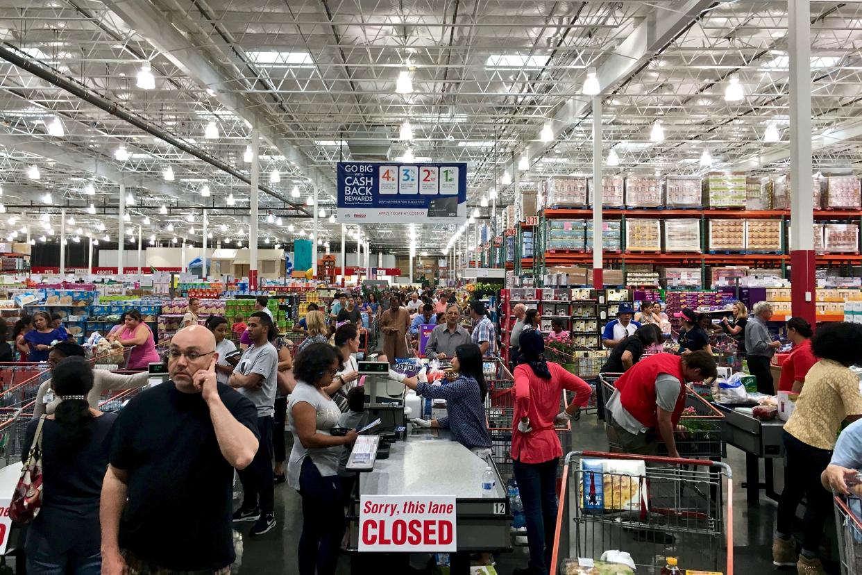 Costco Wholesale showing a large influx of shoppers, creating long checkout lines.