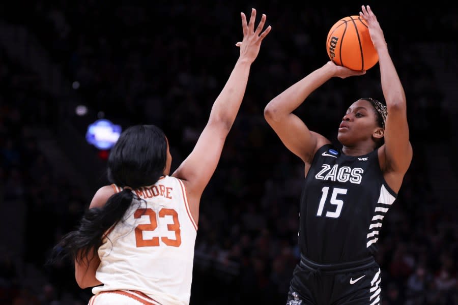 Gonzaga forward Yvonne Ejim (15) shoots as Texas forward Aaliyah Moore (23) defends during the first half of a Sweet 16 college basketball game in the women’s NCAA Tournament, Friday, March 29, 2024, in Portland, Ore. (AP Photo/Howard Lao)