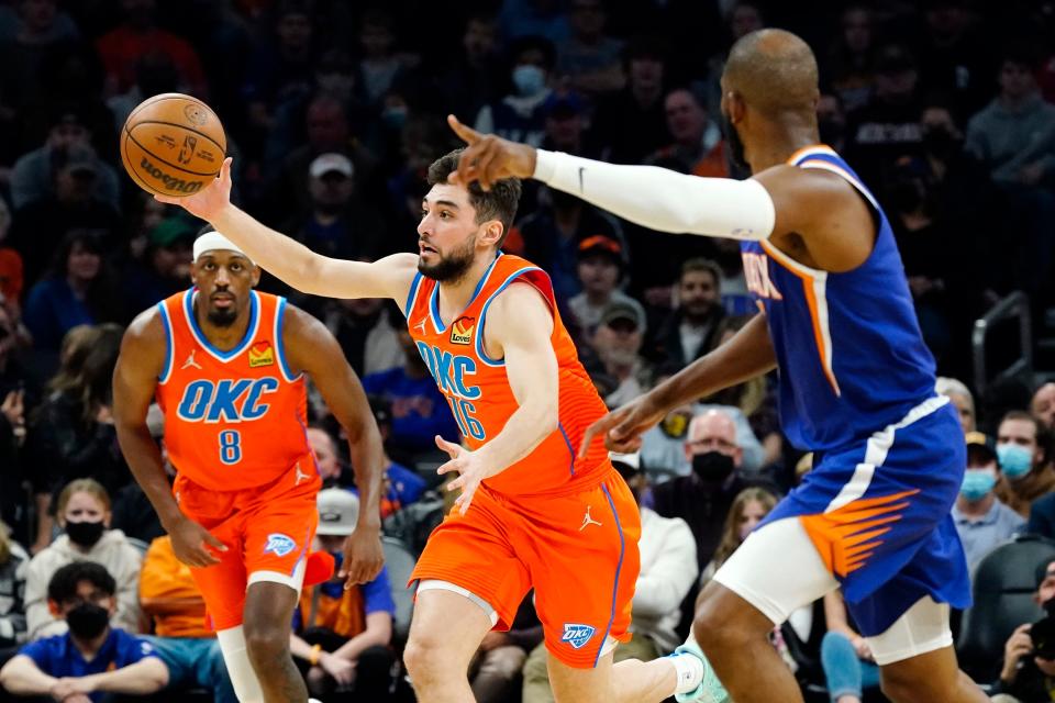 Oklahoma City Thunder guard Ty Jerome (16) steals the ball as Phoenix Suns guard Chris Paul, right, runs back on defense while Thunder guard Paul Watson (8) looks on during the first half of an NBA basketball game Wednesday, Dec. 29, 2021, in Phoenix. (AP Photo/Ross D. Franklin)