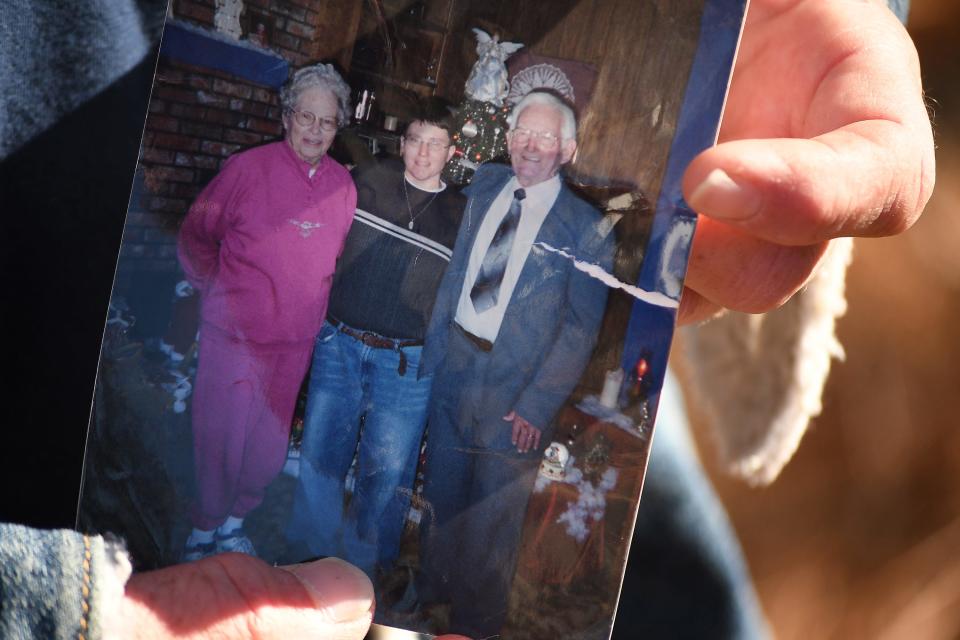 Lona Currie, advisory board member of Coastal Horizons, holds a photo of himself with his grandparents at his residence in Bolivia, N.C., Wednesday Jan. 17, 2024. Currie said he wants to stay clean to represent them. KEN BLEVINS/STARNEWS