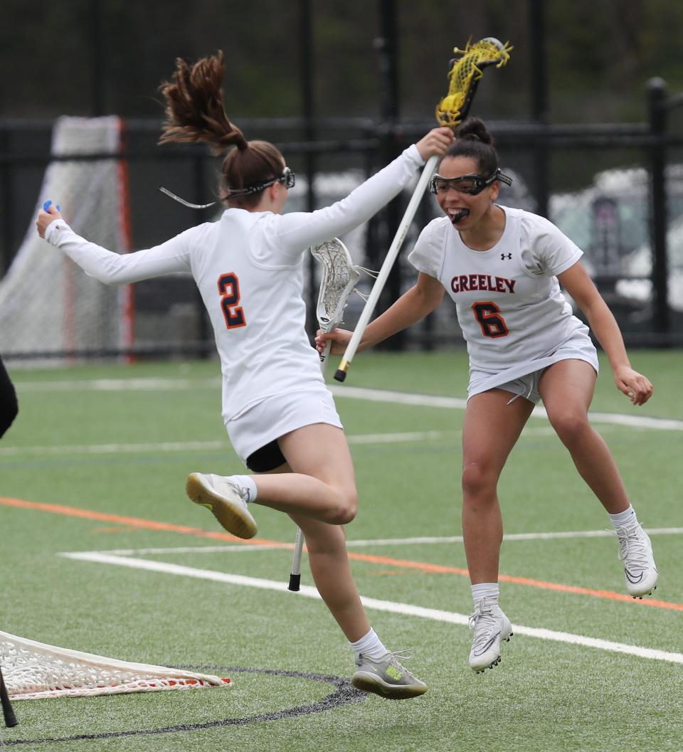 Greeley's Molly Byrne (2) and Bae Bounds (6) celebrate a goal during the Quakers' 13-9 win over Fox Lane in girls lacrosse at Horace Greeley High School in Chappaqua May 4, 2022.