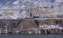 In this Dec. 14, 2016, photo the Horseshoe Bend Treatment Plant is seen at the far shore of the Berkeley Pit in Butte, Mont. Federal officials plan to pump the toxic water into the plant starting in 2023 to keep it below a critical level and prevent it from escaping the pit. (AP Photo/Matt Volz)