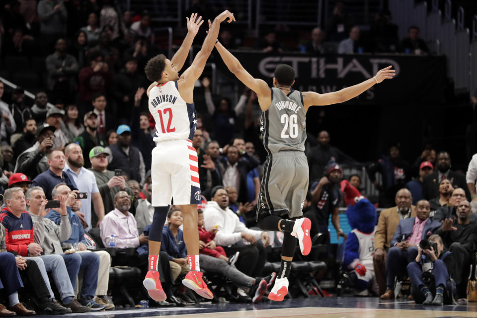 Washington Wizards' Jerome Robinson (12) shoots over Brooklyn Nets' Spencer Dinwiddie (26) during the fourth quarter of an NBA basketball game Wednesday, Feb. 26, 2020, in Washington. The Wizards won 110-106. (AP Photo/Luis M. Alvarez)