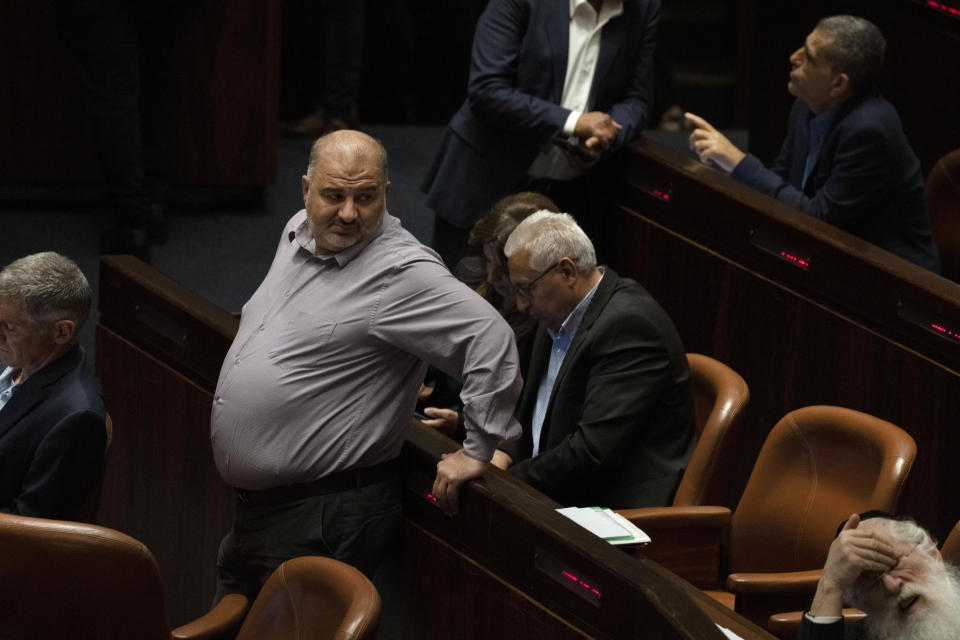 Lawmaker Mansour Abbas, center left, pauses during a session of the Knesset, Israel's parliament, ahead of an expected vote on the legal status of Jewish settlers in the occupied West Bank, in Jerusalem, Monday, June 6, 2022. (AP Photo/ Maya Alleruzzo)