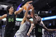 Northwestern guard Boo Buie (0) drives to the basket against Chicago State guard Jahsean Corbett (24) and guard Brent Davis (12) during the first half of an NCAA college basketball game in Evanston, Ill., Wednesday, Dec. 13, 2023. (AP Photo/Nam Y. Huh)