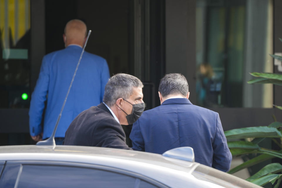 Former minister of interior Matteo Salvini, right, arrives at Palermo's court to attend a trial, in Palermo, Saturday, Oct. 23, 2021. Salvini is accused of kidnapping more than one hundred migrants and keeping them for weeks on board of the small Open Arms rescue boat in front of the coasts of Lampedusa, after refusing to let it dock in an Italian port, in 2019. (AP Photo/Gregorio Borgia)