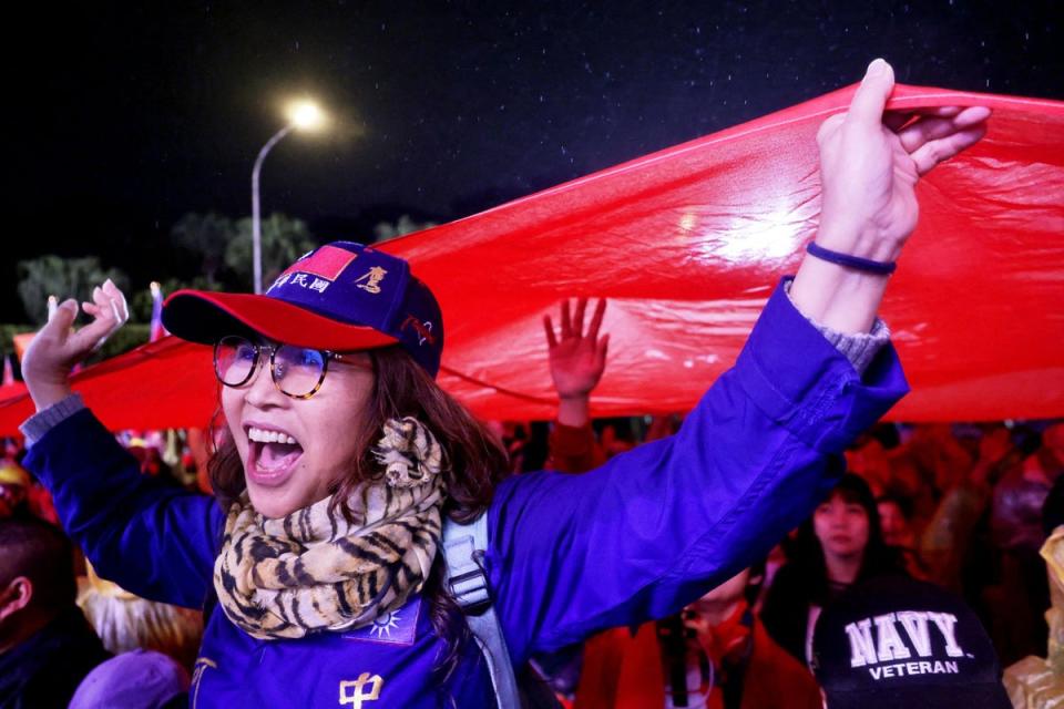 Supporters hoist a giant Taiwan national flag during a campaign rally of Kuomintang (KMT) ahead of Taiwan's presidential election, in Taipei on December 23, 2023 (AFP via Getty Images)