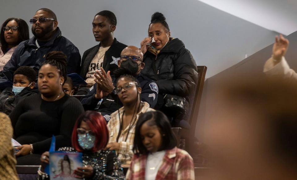 A person uses a tissue to wipe her tears from her eyes inside the Zion Hope Baptist Church during Arielle Diamond Anderson's church service in Detroit on Feb. 21, 2023. Anderson was one of three students killed during a mass shooting at Michigan State University on Feb. 13, 2023.