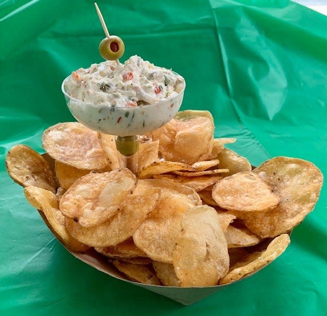 Dirty Martini Dip with Homemade Chips is one of the new food options for the 2022 Wisconsin State Fair. It is blue cheese dip with green olives and onions served in a martini glass with a side of chips. It will be located at Slim McGinn's Irish Pub.