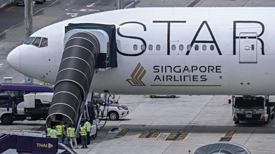 PHOTO: Officials enter the Singapore Airlines Boeing 777-300ER airplane parked on the tarmac at Suvarnabhumi International Airport in Bangkok on May 22, 2024. (Lillian Suwanrumpha/AFP via Getty Images)