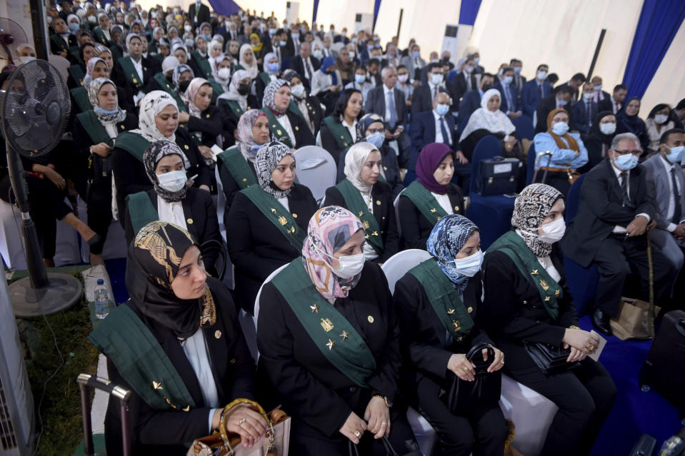 New judges and others attend a swearing-in ceremony before Egypt’s State Council, in Cairo, Egypt, Tuesday, Oct. 19, 2021. Ninety eight women have become the first female judges to join the council, one of the country’s main judicial bodies. The swearing-in came months after President Abdel Fattah el-Sissi asked for women to join the State Council and the Public Prosecution, the two judicial bodies that until recently were exclusively male. (AP Photo/Tarek Wajeh)