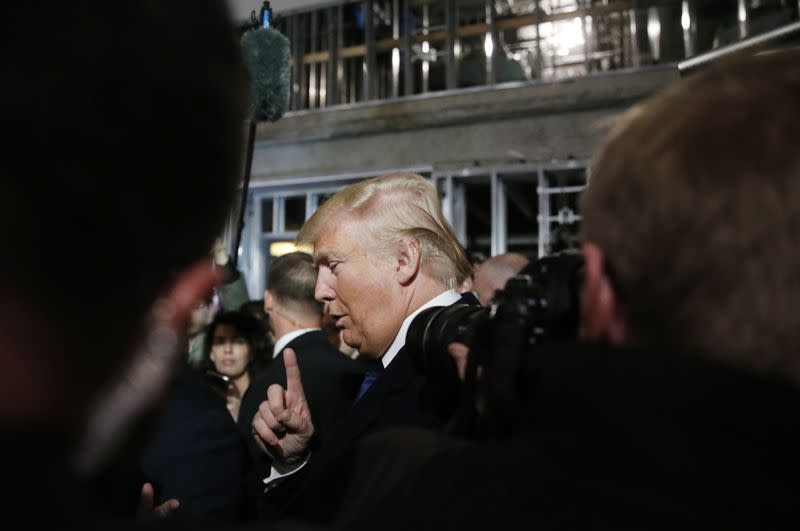 Republican U.S. presidential candidate Trump speaks to reporters while touring Trump Hotel construction site in Washington