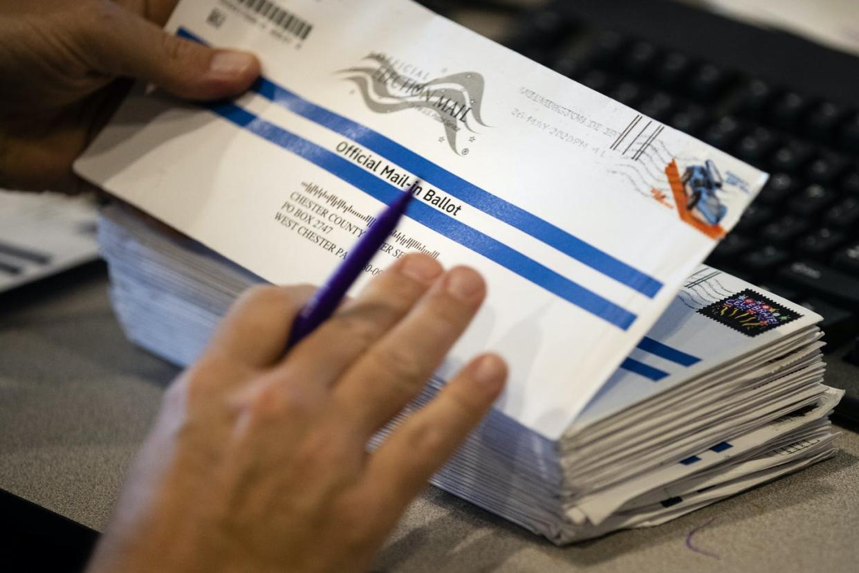 <span class="caption">An election worker in Pennsylvania handles mailed ballots during that state's primary election in May.</span> <span class="attribution"><a class="link " href="https://newsroom.ap.org/detail/VirusOutbreakElection2020Pennsylvania/b454cee8c1af4bd1b1f0044869707605/photo" rel="nofollow noopener" target="_blank" data-ylk="slk:AP Photo/Matt Rourke;elm:context_link;itc:0;sec:content-canvas">AP Photo/Matt Rourke</a></span>