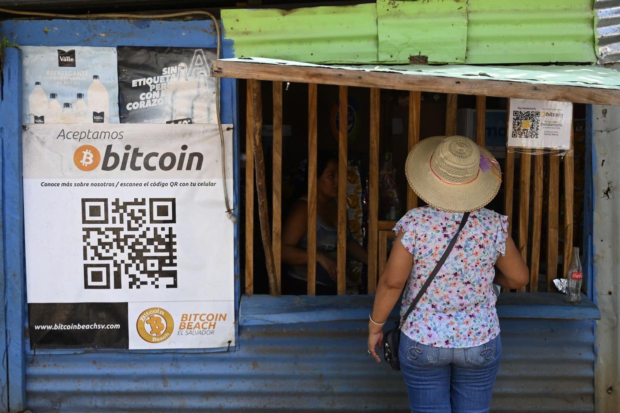A woman outside a store that accepts bitcoins in El Zonte, La Libertad, El Salvador on 4 September 2021 (AFP via Getty Images)