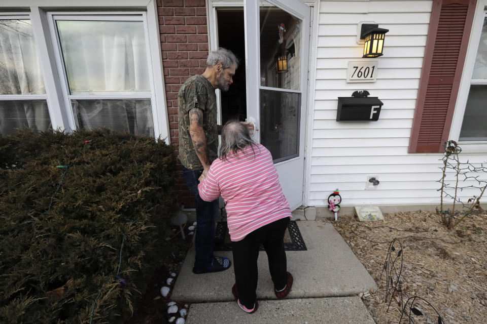 In this Friday, Dec. 20, 2019 photo, Bobby Goldberg, left, and his sister Debbie enter their home in suburban Chicago. Goldberg has filed a lawsuit claiming he was abused more than 1,000 times in multiple states and countries by the late Donald McGuire, a prominent American Jesuit priest who had close ties to Mother Teresa. (AP Photo/Nam Y. Huh)