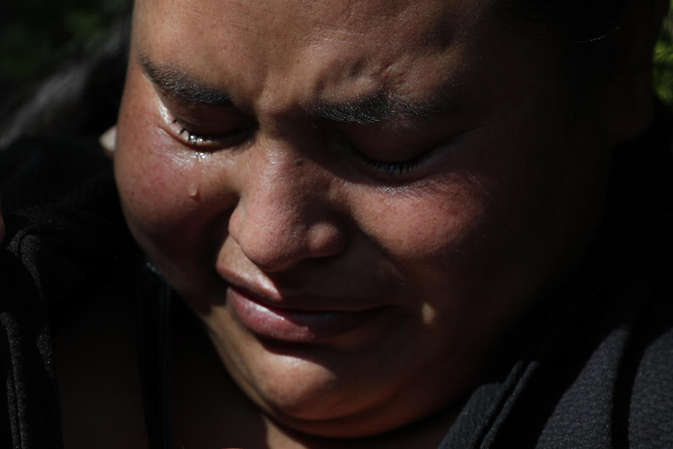 Gabriela Gomez grieves for her sister Rosa who was killed at the scene where police chief Omar Garcia Harfuch was attacked by gunmen in Mexico City, Friday, June 26, 2020. Heavily armed gunmen attacked and wounded Mexico City's police chief in an operation that left several dead. (AP Photo/Rebecca Blackwell)