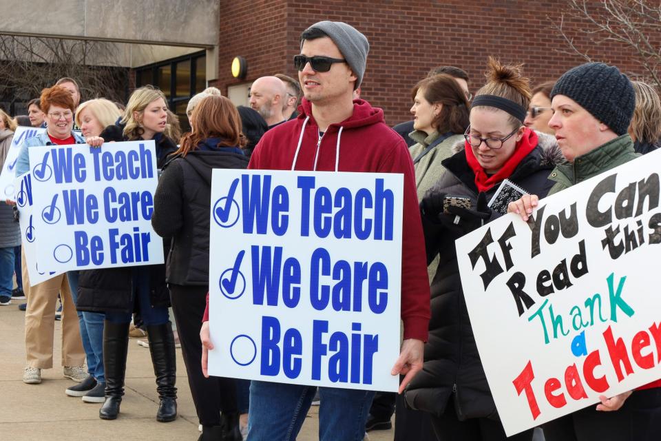 Teachers and community members held signs reading "We teach. We care. Be fair." outside of Hopewell Junior High School on March 28, 2023. Earlier this week, members of the Hopewell Education Association announced they had authorized a strike if they deem it necessary.