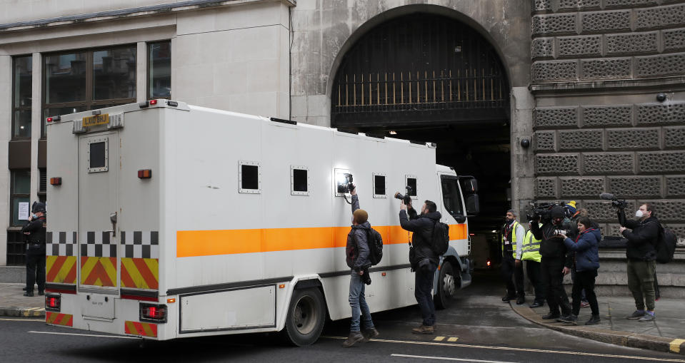 <p>Journalists try to take pictures of the inside of a prison van moving into the Old Bailey, the Central Criminal Court in London, Tuesday, March 16, 2021. Serving British police officer Wayne Couzens stands accused of the kidnap and murder of 33-year-old Sarah Everard, who went missing while walking home in south London on March 3.(AP Photo/Frank Augstein)</p>
